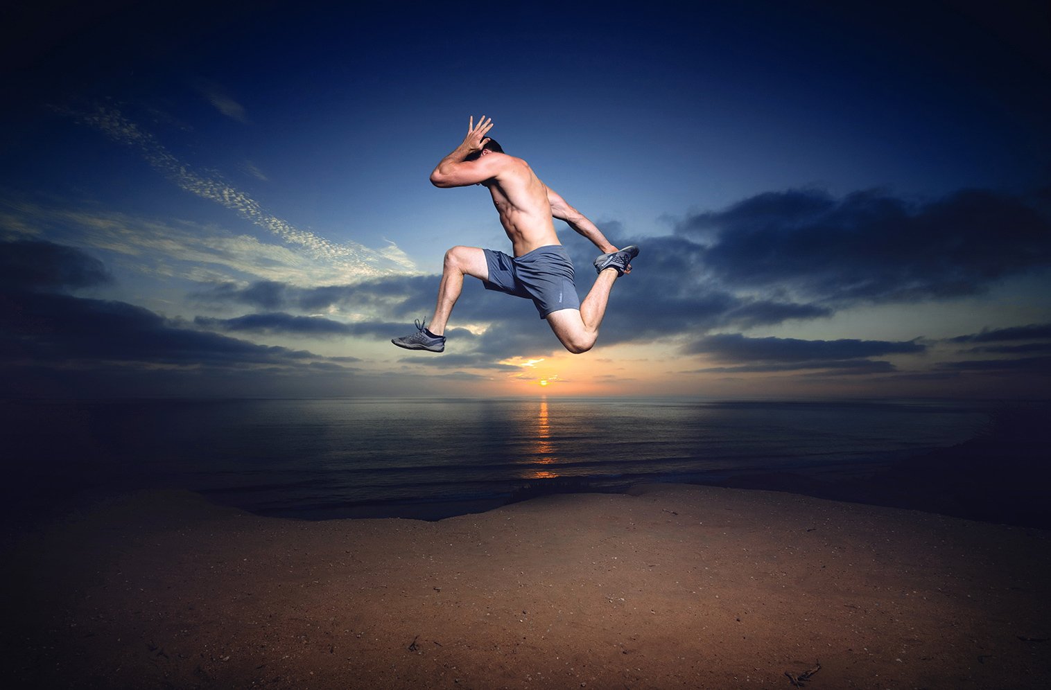 An athlete leaping above the coast at sunset, from Fit Men Project’s original photography